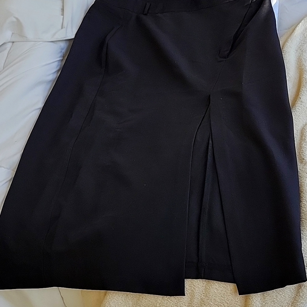 Brand new long black polyster/rayon skirt with slit.